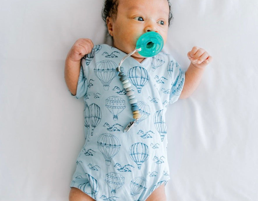 Bon voyage design short-sleeve baby onesie in bamboo cotton fabric.