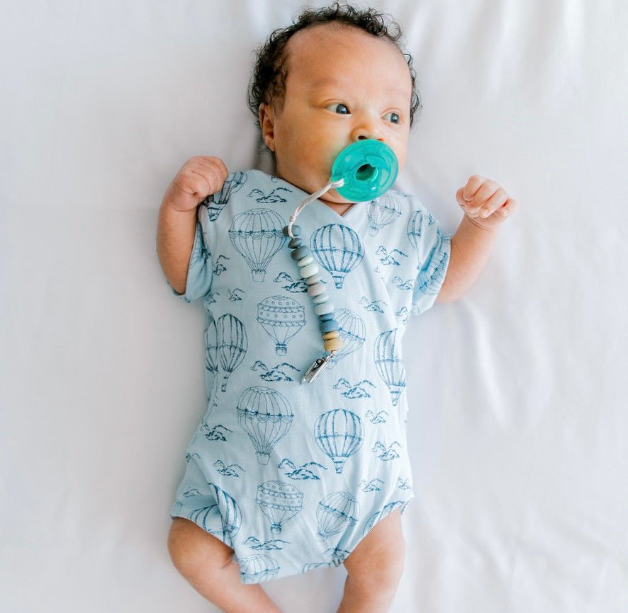 Bon voyage design short-sleeve baby onesie in bamboo cotton fabric.