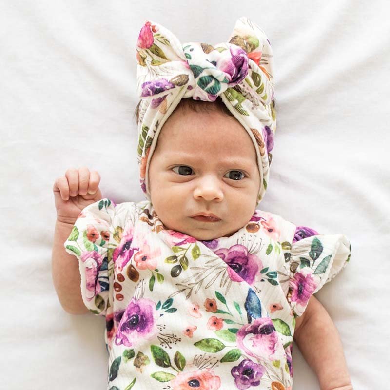 Charming baby headwrap with decorative bow in Ivory Wildflowers styles.