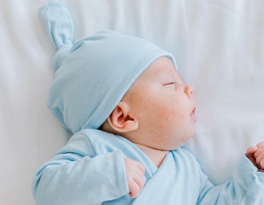 Classic brushed newborn essentials bundle, featuring a long sleeve top with ruffle cuffs in bon voyage design.