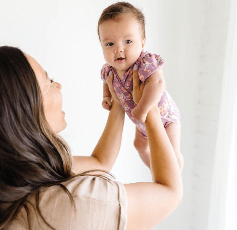 Floral Peachy Lilac short-sleeve bodysuit for baby in Classic Brushed fabric styles.