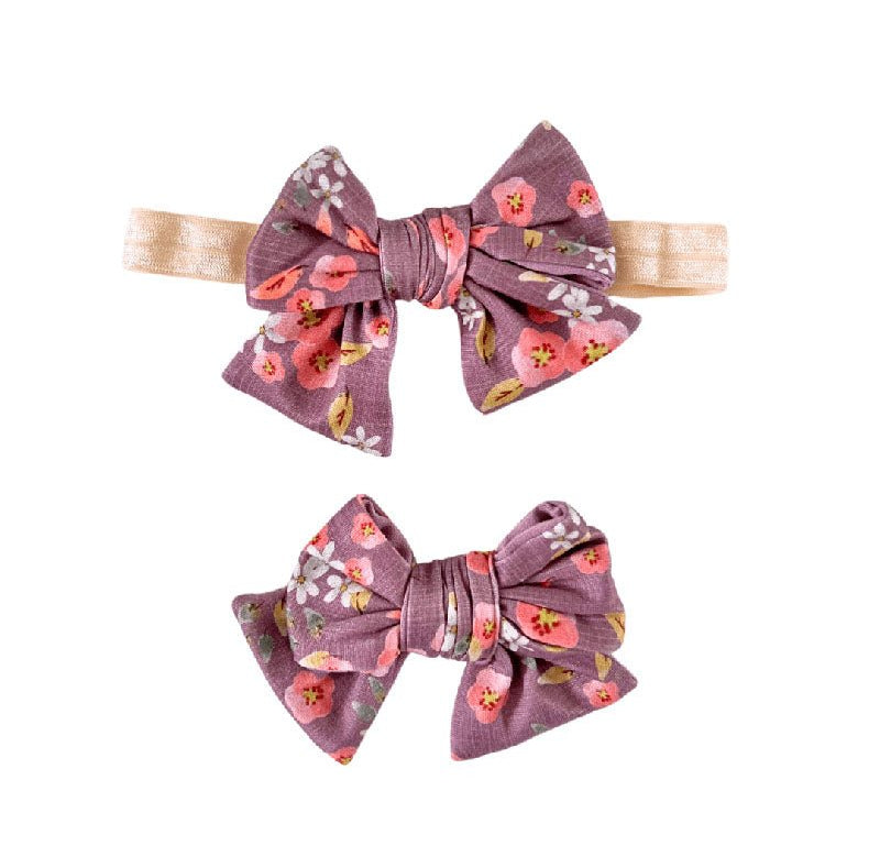 Floral baby bow headband and clip set in the Peachy Lilac pattern.