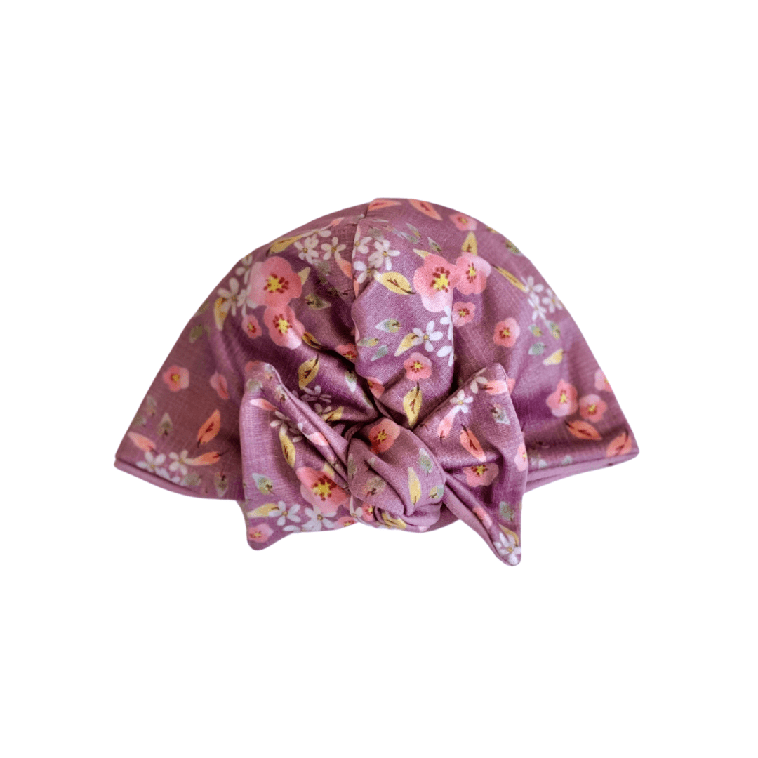 Adorable ruched beanie with bow for babies in Peachy Lilac with a soft stretchy fit.