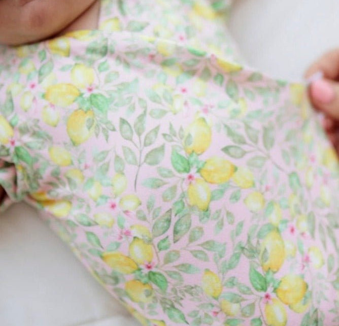 Pink Lemonade floral baby bodysuit with short sleeves in Classic Brushed fabric styles.