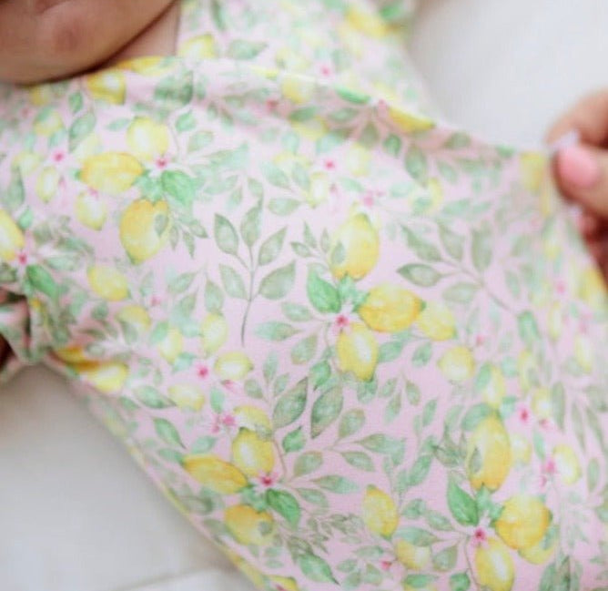 Pink Lemonade floral baby bodysuit with short sleeves in Classic Brushed fabric styles.