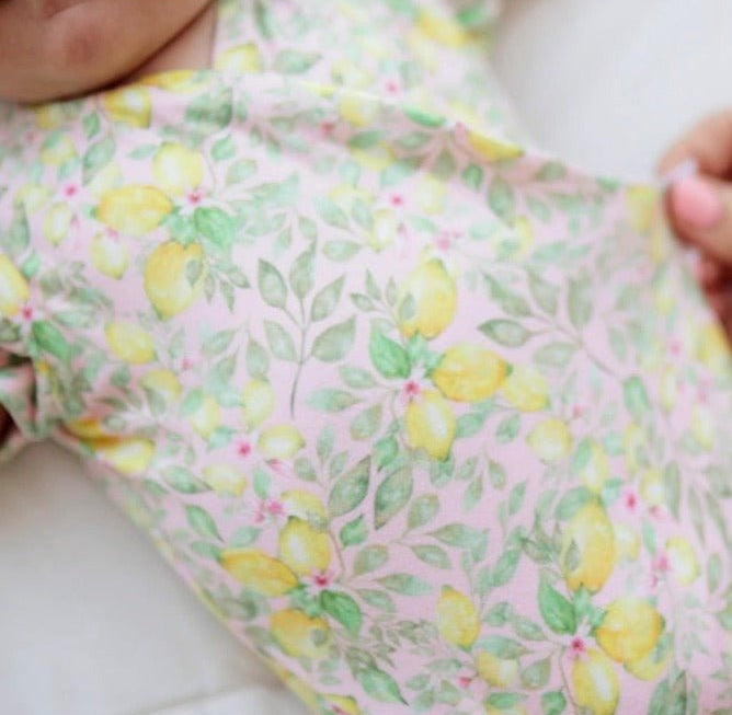Pink Lemonade floral baby bodysuit with short sleeves in Classic Brushed fabric styles.