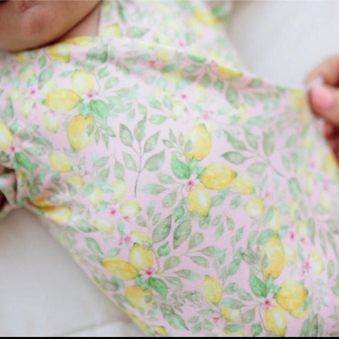 Pink Lemonade floral baby bodysuit with short sleeves in Classic Brushed fabric styles.