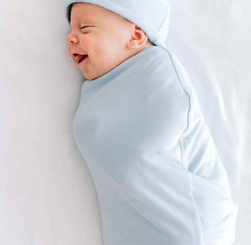 Reversible bon voyage design cocoon baby swaddle in bamboo cotton fabric.