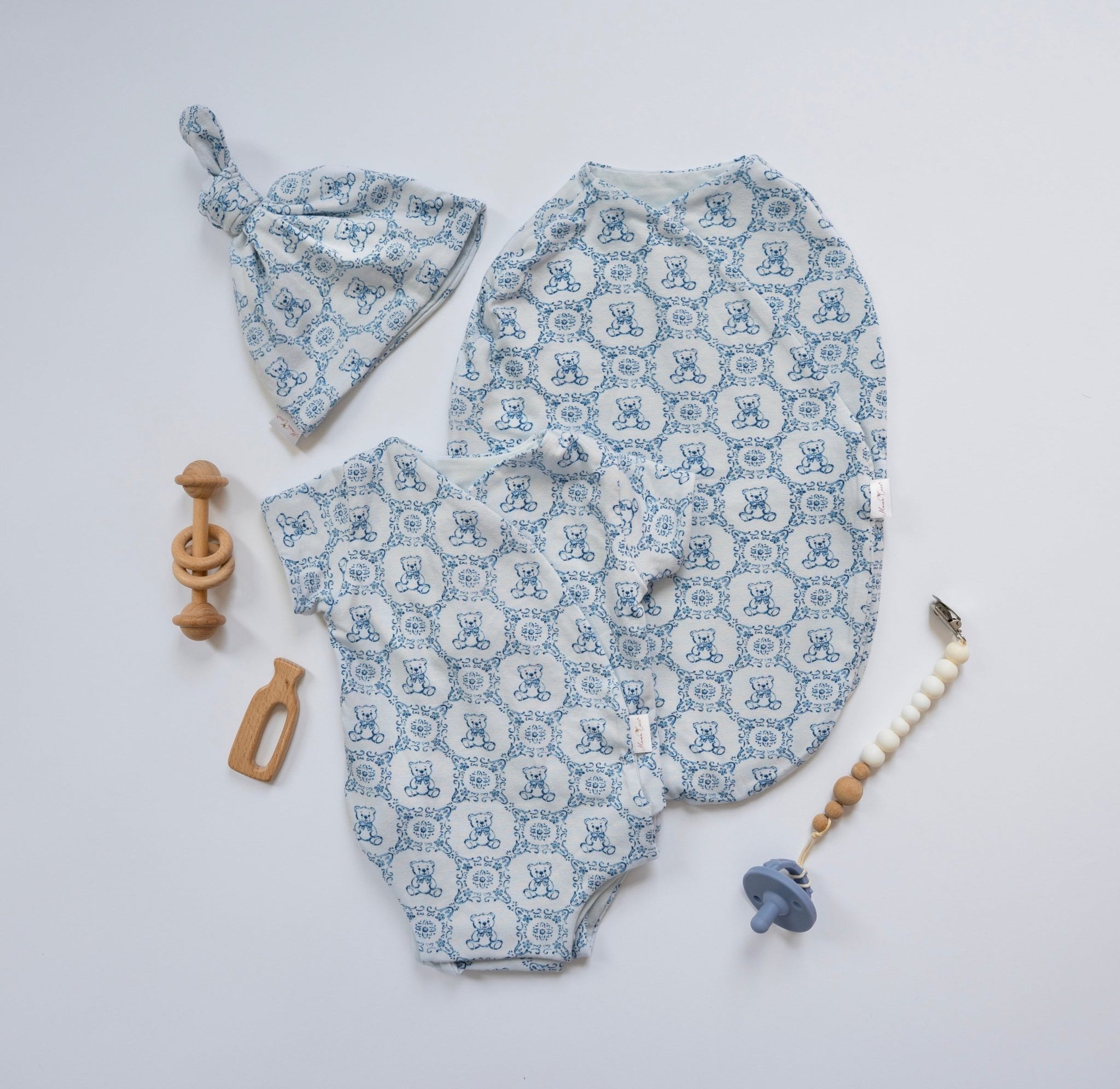 Organic bamboo cotton cocoon baby swaddle blanket with Teddy Tiles design.