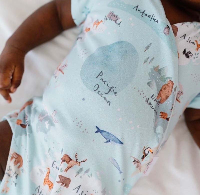 Soft classic brushed short-sleeve winged bodysuit featuring the World Traveler design.