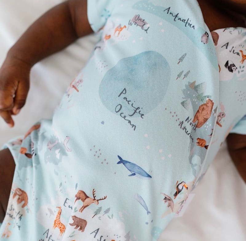 Soft classic brushed short-sleeve winged bodysuit featuring the World Traveler design.