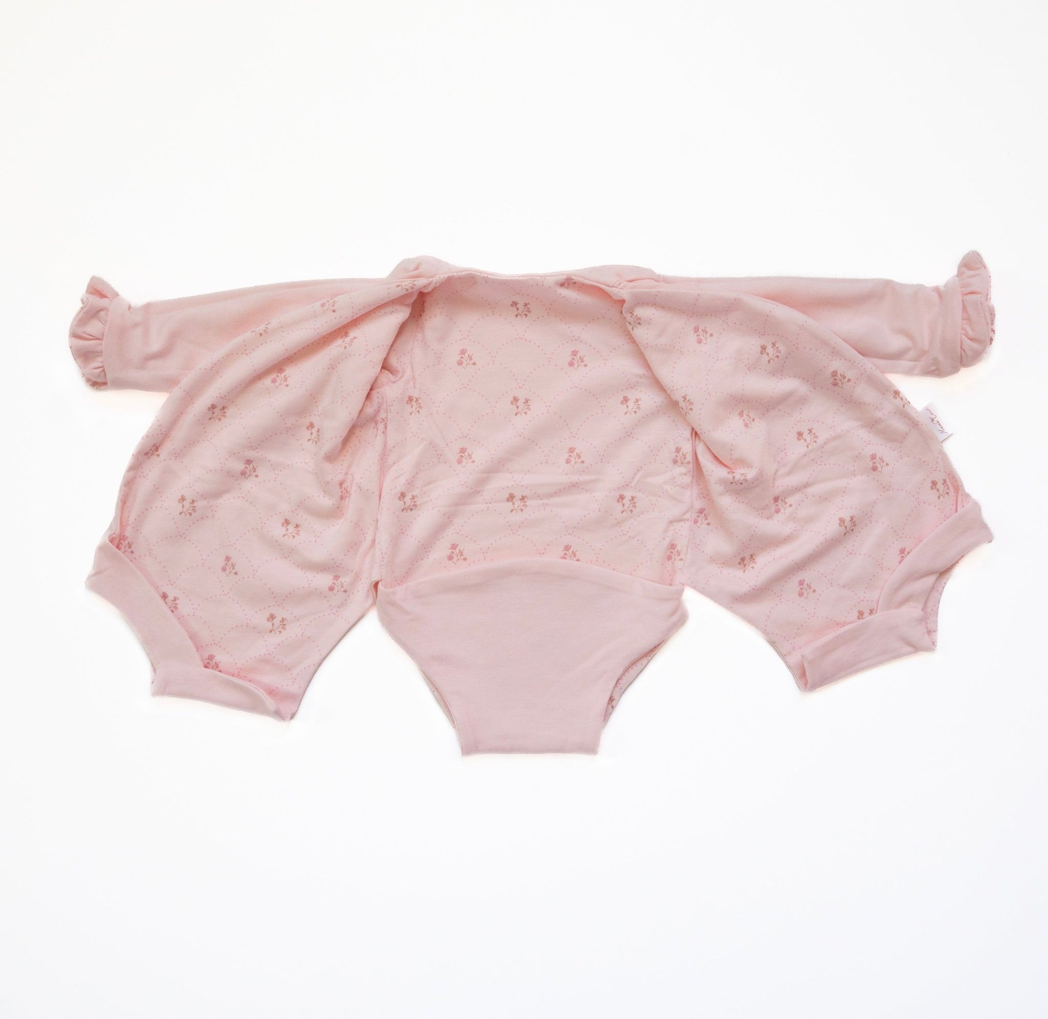Ruffle cuff long sleeve baby winged bodysuit made from bamboo cotton in dainty dots design.