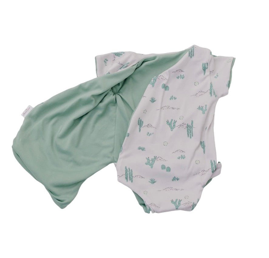 Soft reversible short-sleeve winged bodysuit in the Desert Sunsets design crafted from classic brushed fabric.