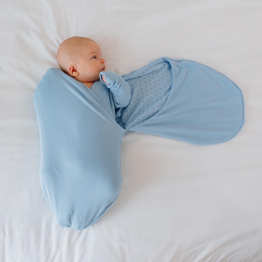 Cocoon swaddle baby blanket in Silky Modal fabric styles accented by Dotted Blues details.