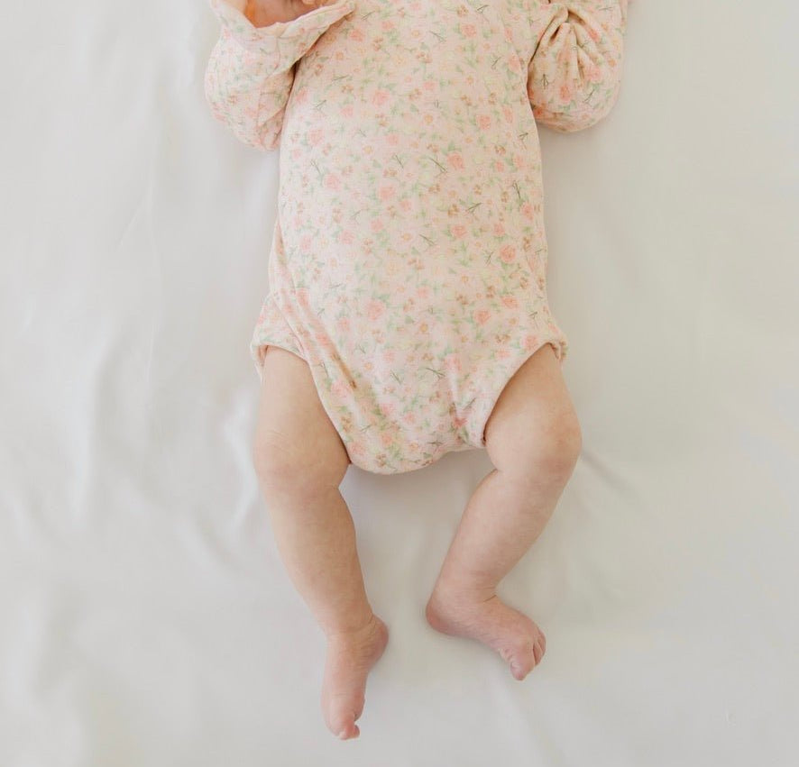 Classic brushed fabric baby bodysuit in Dusty Roses design with long sleeves, winged, and ruffle cuffs.