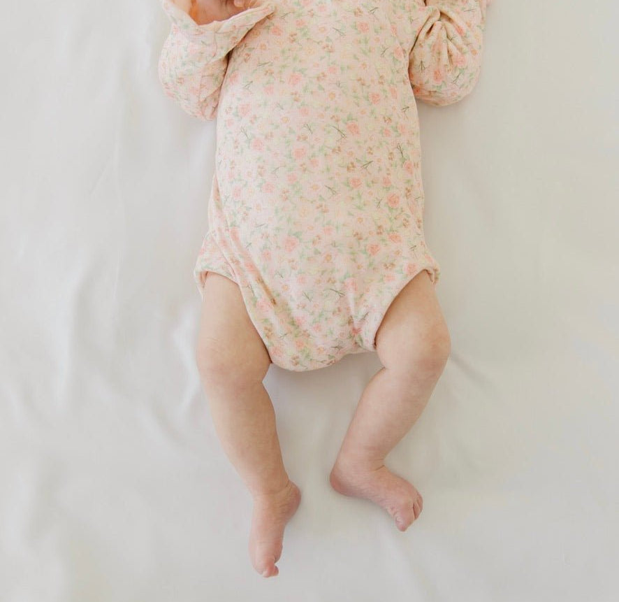 Classic brushed fabric baby bodysuit in Dusty Roses design with long sleeves, winged, and ruffle cuffs.