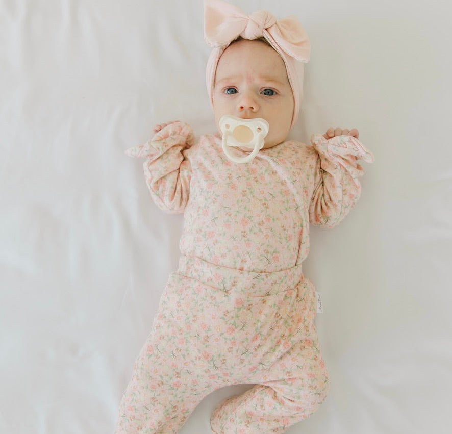 Soft Dusty Roses design brushed fabric baby bodysuit with winged sleeves and elegant ruffle cuffs.