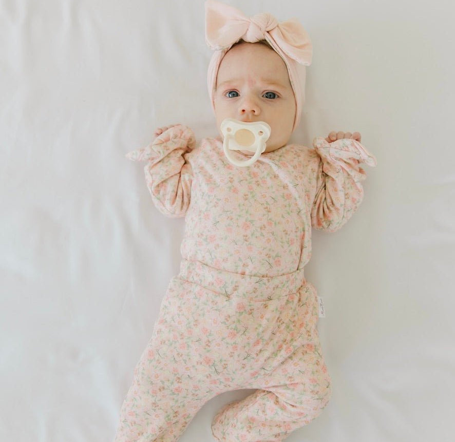 Soft Dusty Roses design brushed fabric baby bodysuit with winged sleeves and elegant ruffle cuffs.