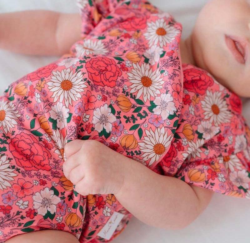 Short-sleeve bodysuit for baby in Classic Brushed fabric styles featuring Flower Power.
