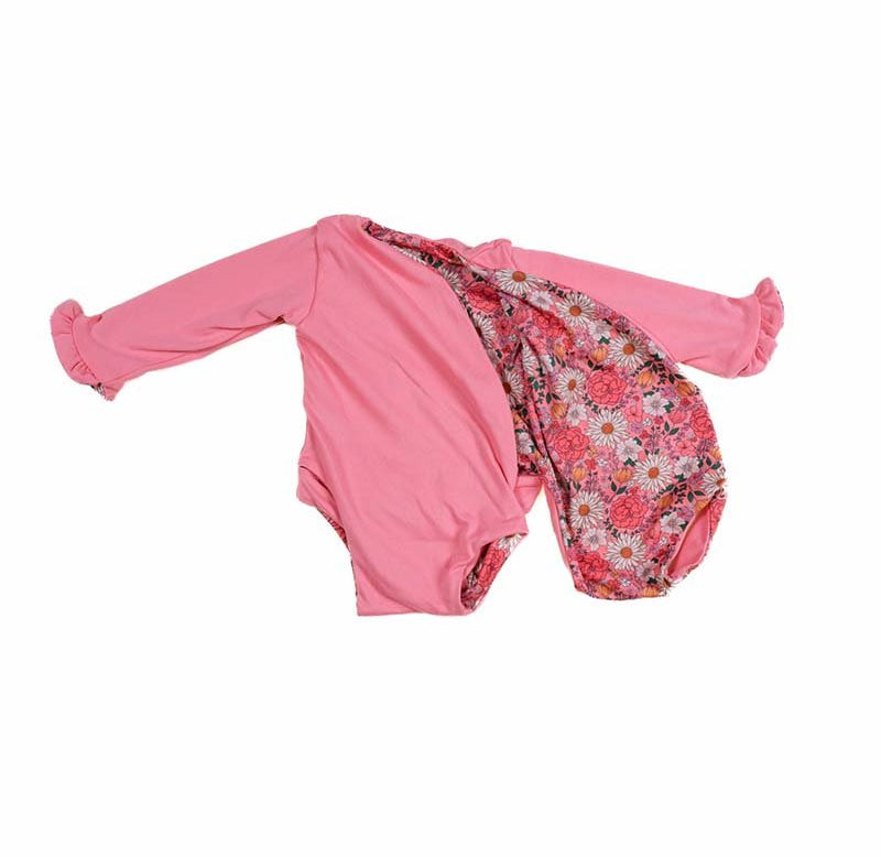 Baby long sleeve bodysuit in Flower Power design brushed fabric featuring wing details and ruffle cuffs.