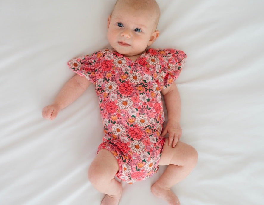 Flower power design flutter sleeve baby onesie in classic brushed fabric.