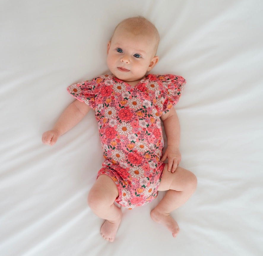 Flower power design flutter sleeve baby onesie in classic brushed fabric.