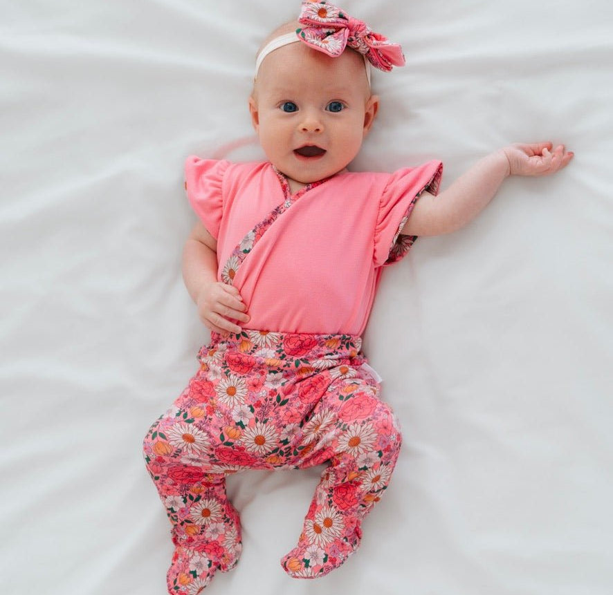 Reversible short-sleeve bodysuit for baby showcasing Flower Power and premium brushed fabric.
