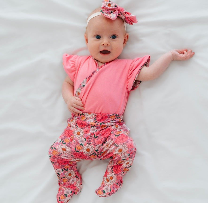 Reversible short-sleeve bodysuit for baby showcasing Flower Power and premium brushed fabric.