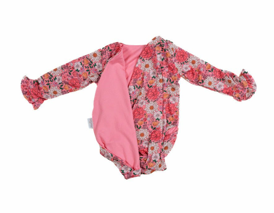 Reversible flower power long sleeve ruffle cuff baby onesie.