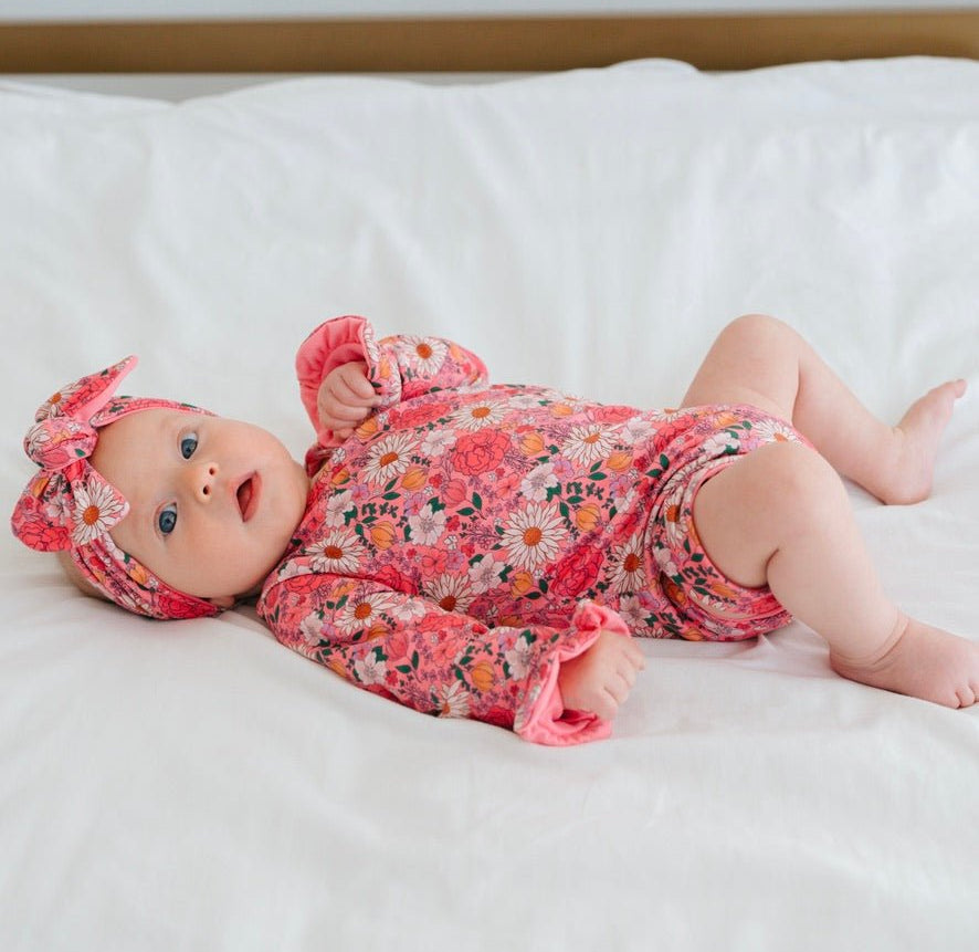 Long sleeve winged baby bodysuit featuring ruffle cuffs in soft Flower Power design brushed fabric.