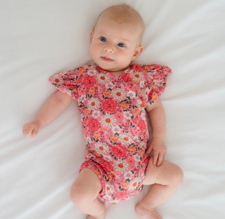 Flower Power short-sleeve bodysuit for baby in Classic Brushed fabric styles with a vibrant floral print.