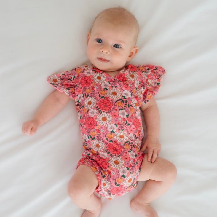 Flower Power short-sleeve bodysuit for baby in Classic Brushed fabric styles with a vibrant floral print.