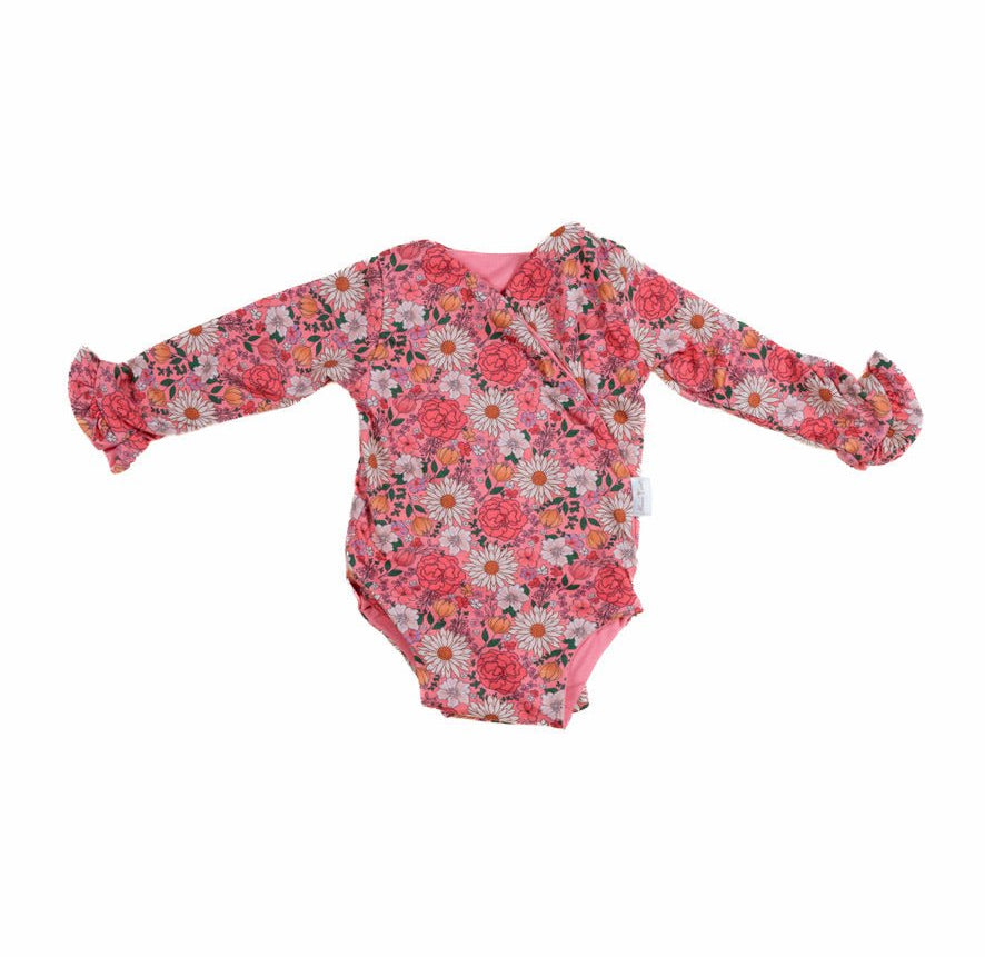 Winged long sleeve infant bodysuit crafted from cozy Flower Power design brushed fabric with ruffle cuffs.