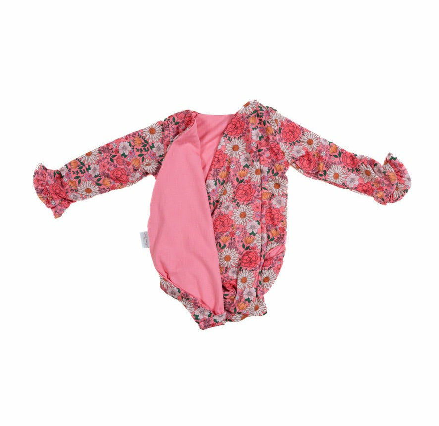 Winged long sleeve infant bodysuit crafted from cozy Flower Power design reversible brushed fabric with ruffle cuffs.