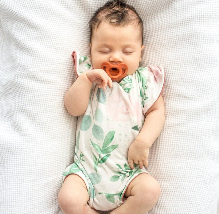 Blushing eucalyptus design flutter sleeve baby onesie.