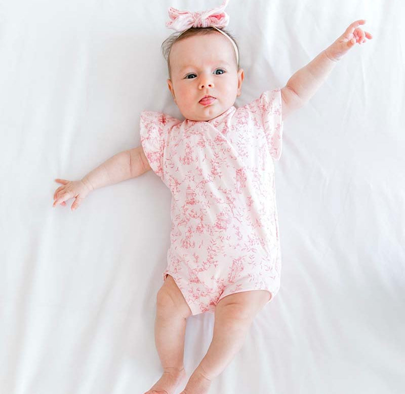 Whimsical garden flutter sleeve baby onesie outfit bundle made from bamboo cotton.