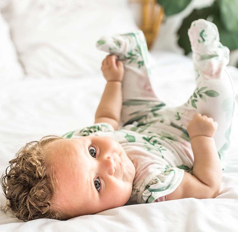 Blushing eucalyptus design flutter sleeve baby onesie.