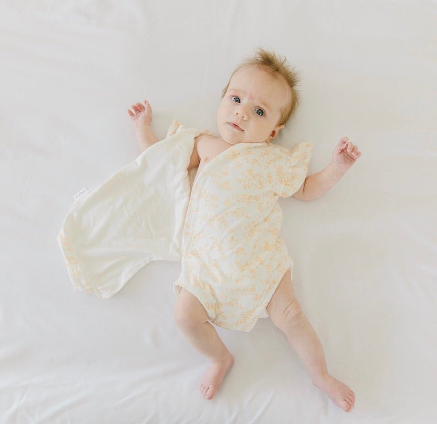 Flutter sleeve baby onesie in Bitty Blooms design.