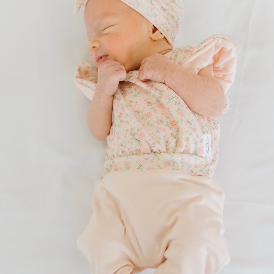 Dusty roses design flutter sleeve baby onesie.