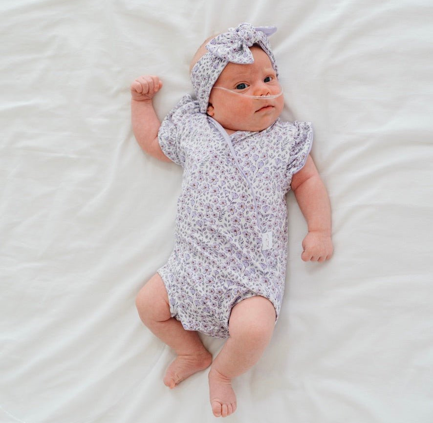 Flutter sleeve baby onesie outfit bundle made from silky modal fabric in purple posies design.