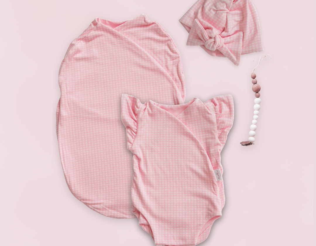 Newborn essentials bundle with flutter sleeves in silky modal fabric with baby pink gingham design.