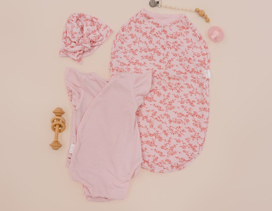 Newborn essentials bundle with flutter sleeves in silky modal fabric with bitty pink blooms design.