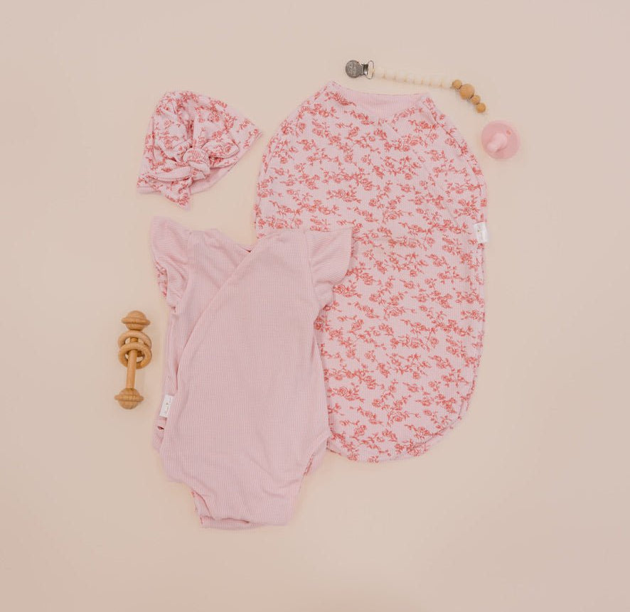 Newborn essentials bundle with flutter sleeves in silky modal fabric with bitty pink blooms design.