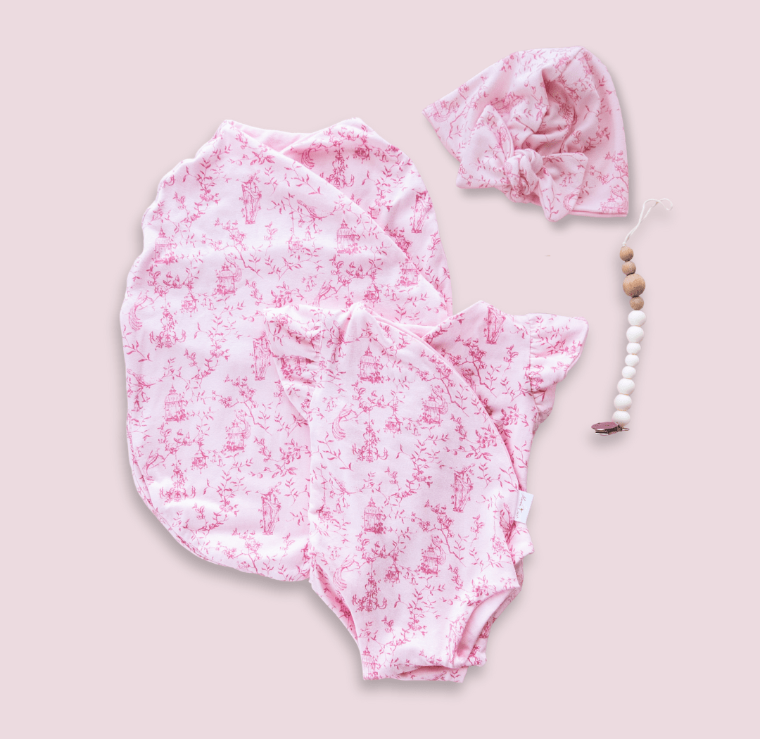 Newborn essentials bundle with flutter sleeves in bamboo cotton fabric with whimsical garden design.