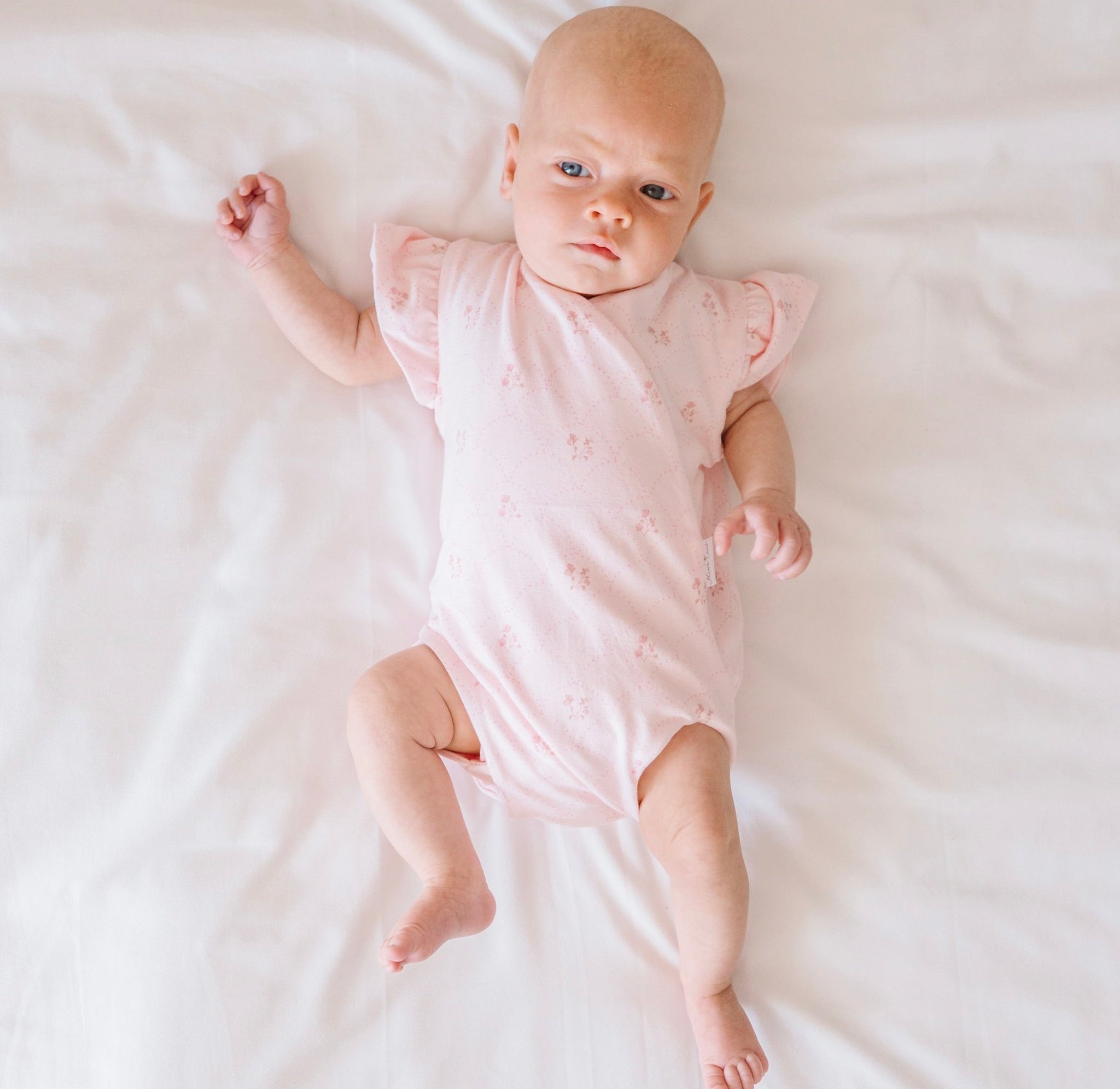 Futter sleeve winged bodysuit for babies in dainty dots design.
