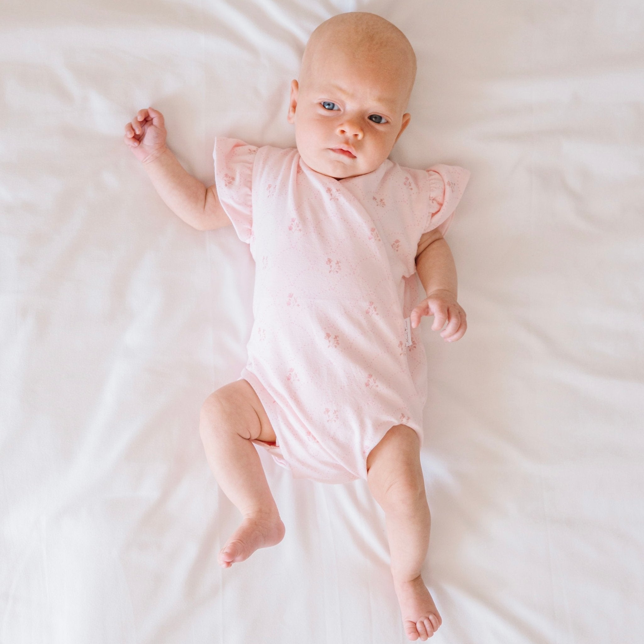 Futter sleeve winged bodysuit for babies in dainty dots design.