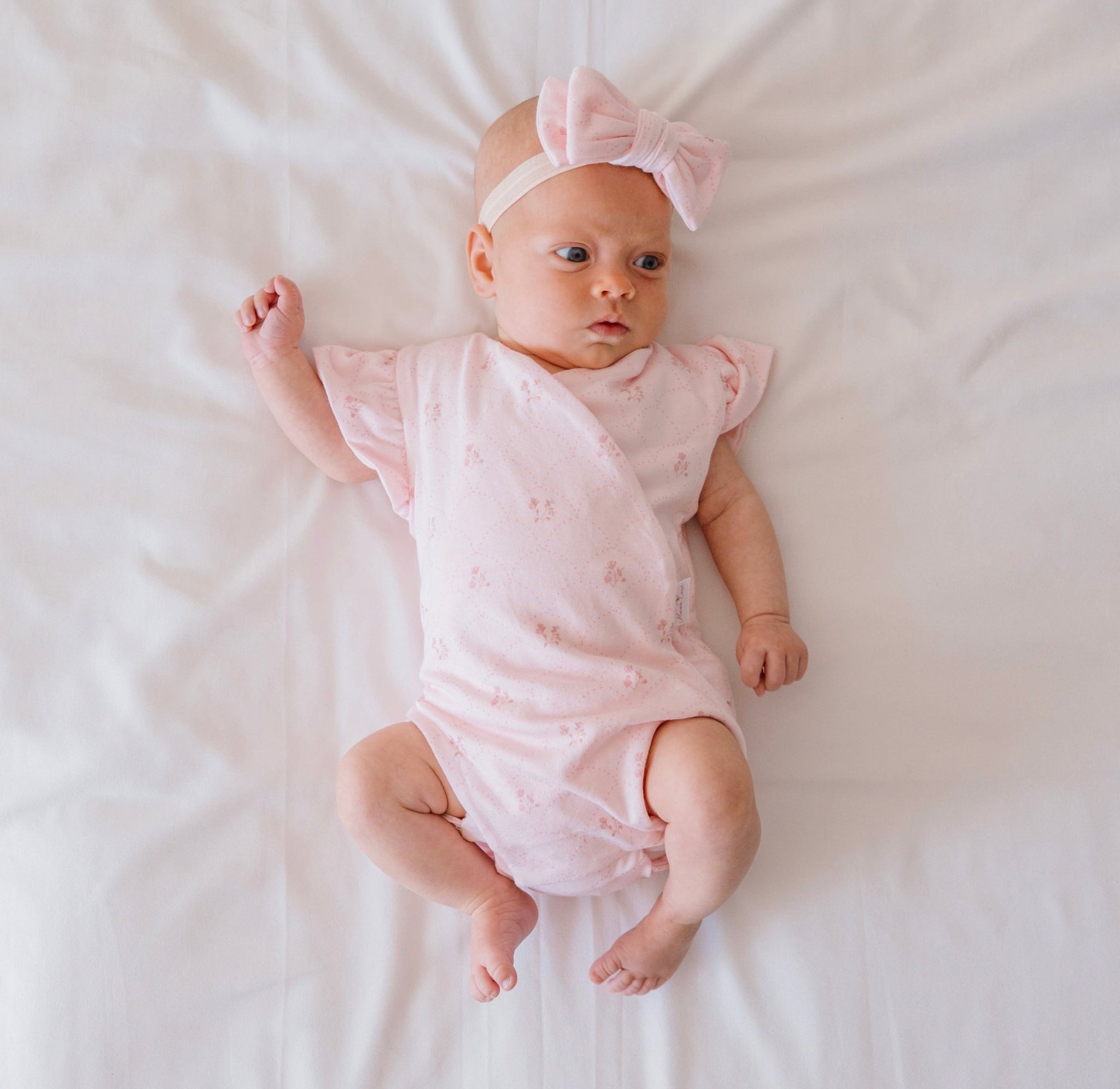 Reversible flutter sleeve winged bodysuit for babies in dainty dots design.