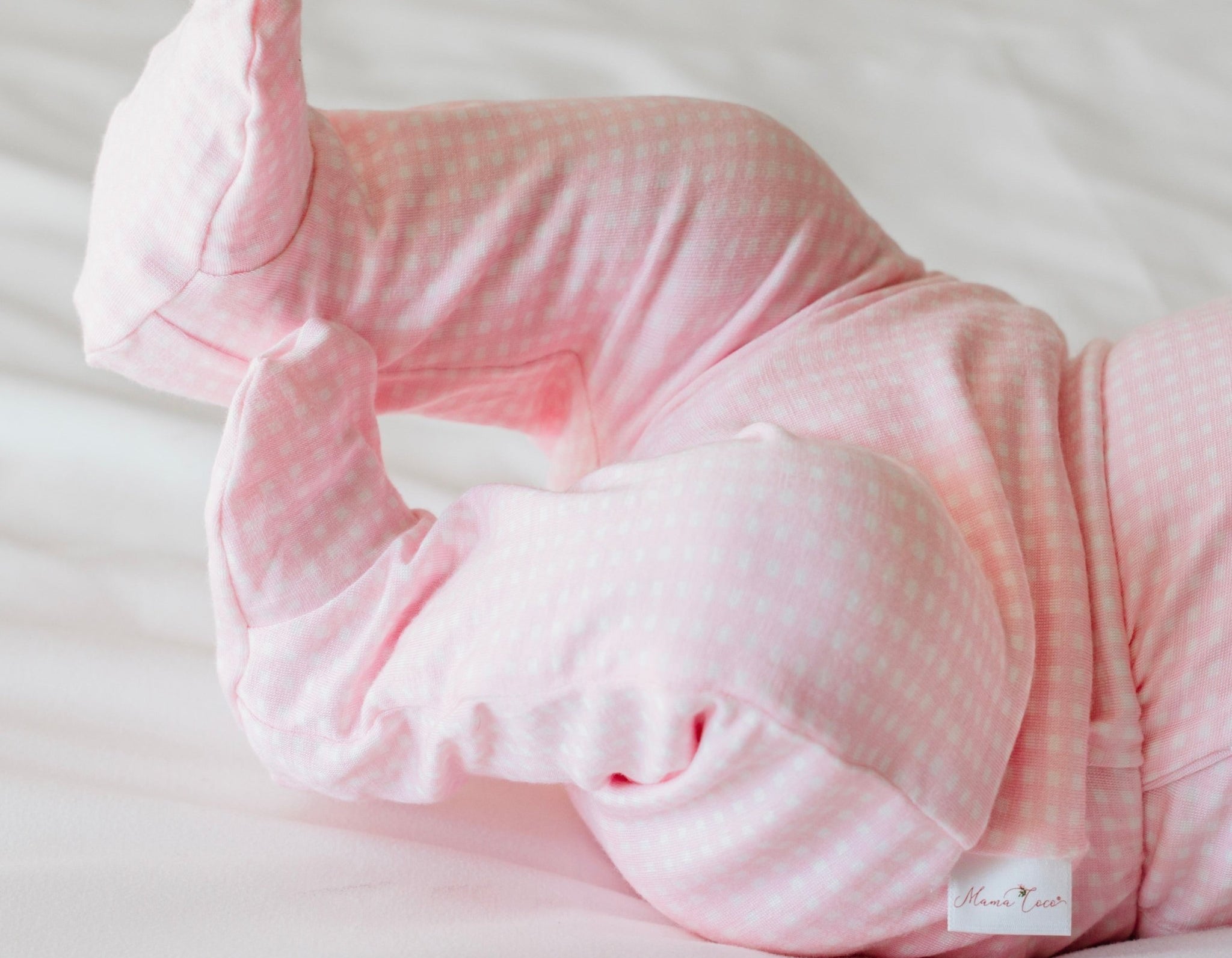 Baby footie pants in baby pink gingham design.