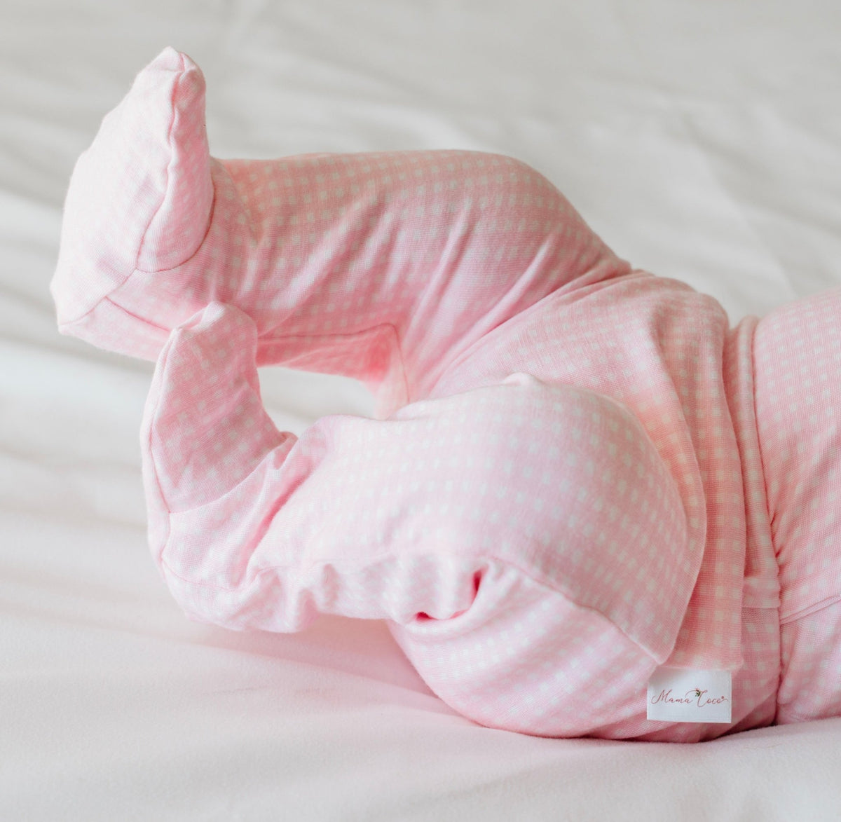 Baby footie pants in baby pink gingham design.