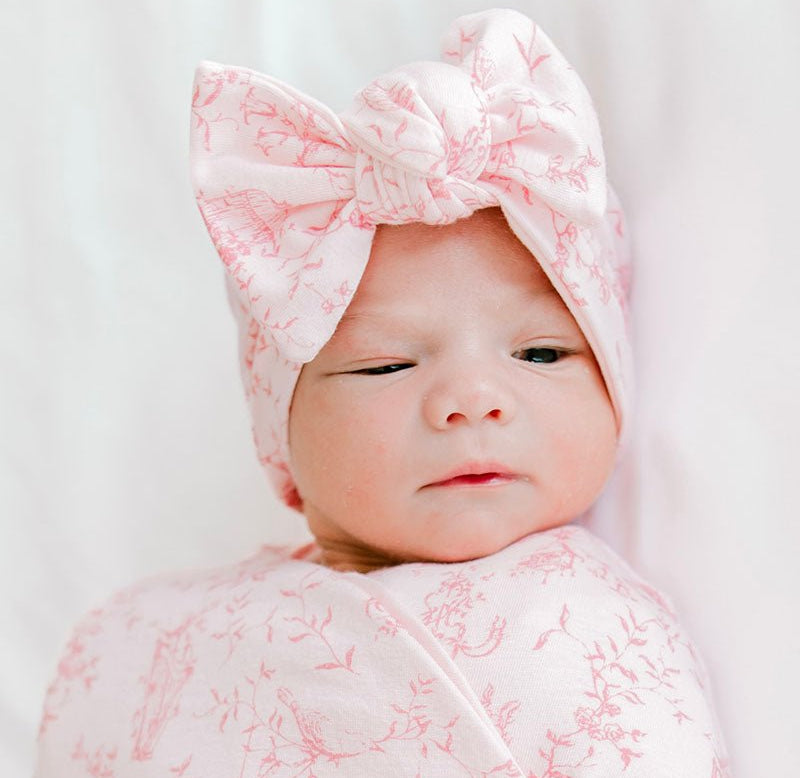 Comfortable baby bow headwrap in a charming whimsical garden print, made from bamboo and organic cotton.